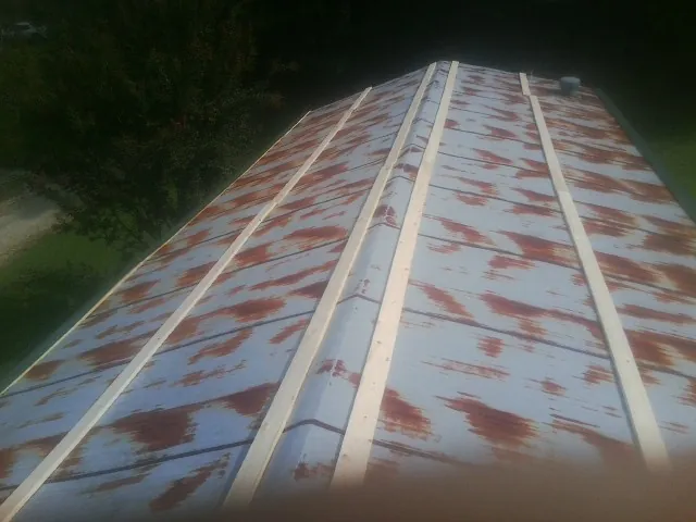 Rusted metal roof panels with new wood purlins before replacement — Storm Damage Roof Repair in Acampo by Roofing Brothers