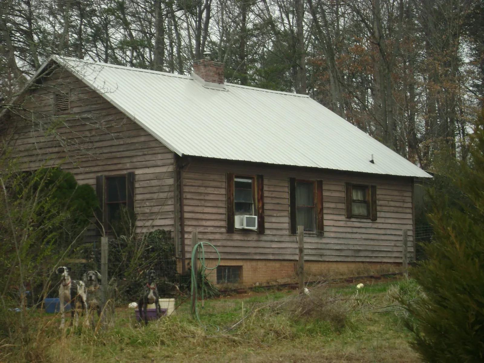White metal roof on an old wood sided farmhouse, from a Metal Roof Installation job in Acampo